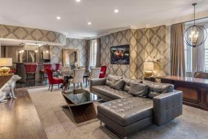 a living room with a couch and a table at The Fort Garry Hotel Spa and Conference Centre, Ascend Hotel Collection in Winnipeg