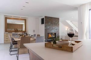 cocina y comedor con copa de vino en Naramia Sagaro Villa with Poolgarden10 Pax, en S'Agaró