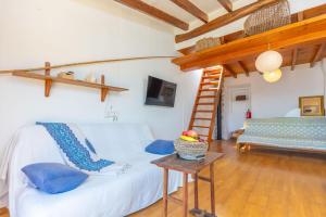 a room with a white bed with blue pillows at Cas Padrins -Portopetro- in Portopetro