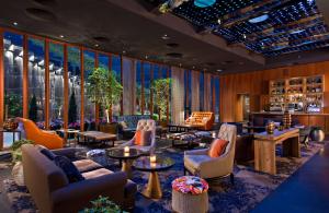 a lobby with couches and chairs and a bar at Dream Downtown, by Hyatt in New York