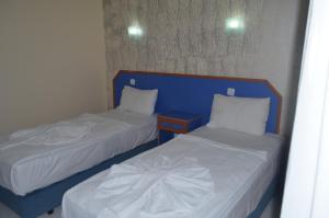 Postel nebo postele na pokoji v ubytování Dilhan Hotel