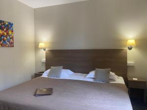 a bedroom with a large bed with a wooden headboard at Grand Hôtel De Calvi in Calvi