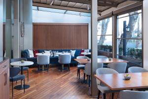 a restaurant with tables and chairs and windows at Delta Hotels by Marriott Istanbul Levent in Istanbul