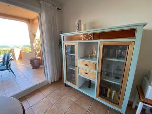 a wooden cabinet in a living room with a balcony at Sagaró sea housegardenbarbacue8 paxsea view in Sant Feliu de Guixols
