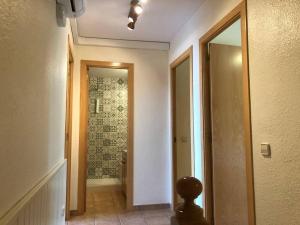 a hallway with a door leading to a bathroom at Sagaró sea housegardenbarbacue8 paxsea view in Sant Feliu de Guixols