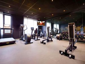 a gym with several treadmills and exercise machines at TRIBE Milano Malpensa in Vizzola Ticino