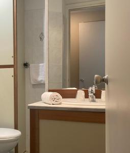 a bathroom with a sink and a mirror at Grand Hôtel De Calvi in Calvi
