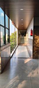 a lobby of a building with a large window at Varaha Residency Lodging and Banquet in Hubli