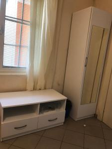 a dressing room with a white cabinet and a mirror at Apartmani Marina in Sutomore +5 photos