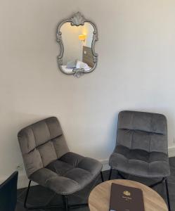 a waiting room with two chairs and a mirror at Grand Hôtel De Calvi in Calvi