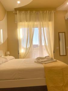 a bedroom with two beds and a window at Terrazza Garibaldi in Naples