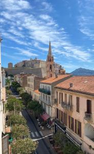 an aerial view of a city with a church at Grand Hôtel De Calvi in Calvi