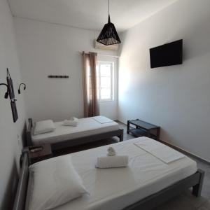 a room with two beds and a tv and a window at Antonia in Galissas