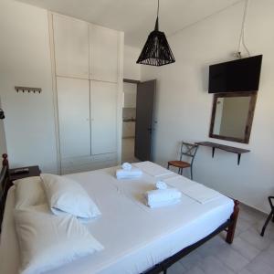 a bedroom with a white bed with two towels on it at Antonia in Galissas