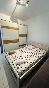 a bed with red hearts on it in a room at Summer Holiday in Shëngjin