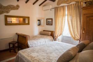 - une chambre avec 2 lits et une fenêtre dans l'établissement Bio Agriturismo Poggio Aione, à Saturnia