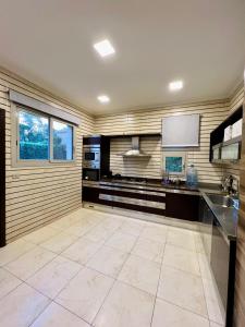 a large kitchen with a counter and a sink at Villa Ultra VIP in Sheikh Zayed +2 photos