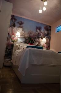 a bedroom with a bed with a painting on the wall at Blue Luxury Apartment in Budapest