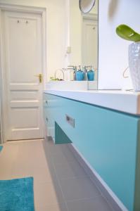 a bathroom with a sink and a blue counter at Blue Luxury Apartment in Budapest