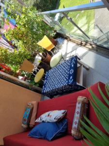 a red couch with pillows sitting on a balcony at Studio im Bezirk Lend in Graz