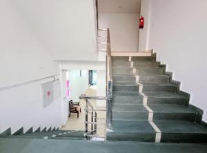 a staircase in a building with a stair case at Hotel Prime Royalty Malviya Nagar in New Delhi