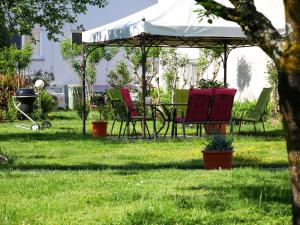 una mesa y sillas bajo un cenador en un patio en Ferienwohnung Walter en Ringsheim