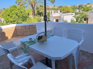 a white table and chairs on a patio at Sabine Apartamento T1 Superior in Albufeira
