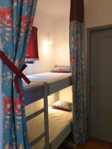 two bunk beds in a room with a curtain at Sabine Apartamento T1 Superior in Albufeira