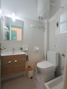 uma casa de banho branca com um WC e um lavatório em Philippos Apartments em Acharavi
