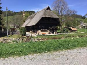 a large wooden building with a thatched roof at Ferienwohnung Lydia in Zell am Harmersbach