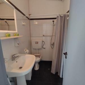 a bathroom with a sink and a toilet and a shower at Antonia in Galissas +66 photos