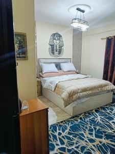 a bedroom with a king sized bed in a room at Sneferu Pyramids inn - Full Pyramids View in Cairo