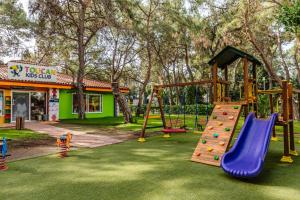 a playground with a slide in a park at Fun & Sun Club Saphire in Tekirova