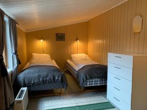 Un pat sau paturi într-o cameră la Rorbu i Lofoten i fantastiske omgivelser