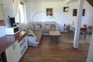 a living room with a couch and a table at Agroturystyka u Klarci in Kiedrowice