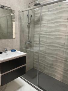 a bathroom with a shower and a sink at SHR043 Nerja Medina Apartamento cerca de Playa Torrecilla in Nerja