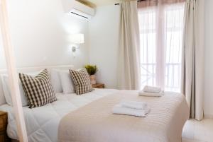 Posteľ alebo postele v izbe v ubytovaní Blue House Apartments