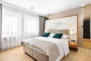 a bedroom with a large bed and a large map on the wall at Rent like home - Deo Plaza Wyspa Spichrzów in Gdańsk