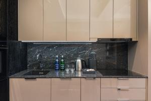 a kitchen with a counter top with a sink at Rent like home - Deo Plaza Wyspa Spichrzów in Gdańsk