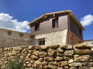 a house behind a stone wall behind a stone fence at La Biste in Mirepoix