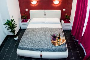 a bedroom with a large white bed with a tray on it at Gio' Suites in Rome