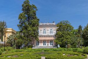 a building with a garden in front of it at ASTORIA Hotel Opatija in Opatija
