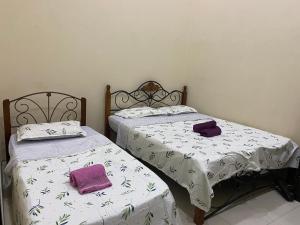 Ένα ή περισσότερα κρεβάτια σε δωμάτιο στο Zulikhwani Homestay (Mersing)