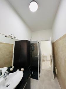 a bathroom with a sink and a shower at Trilocale centro Gallarate in Gallarate +9 photos