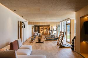 a gym with a bunch of exercise equipment in a room at ANTON Nature Hideaway in Natz-Schabs