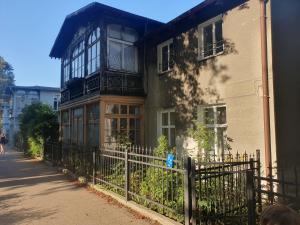 a building with a fence in front of it at Baltic Swans - Studio in Sopot