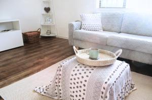 a living room with a coffee table and a couch at Surfside Holiday Home 100m Beach in Batemans Bay