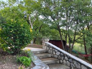 a stone retaining wall with stairs in a park at Canyon View Lodge - Matka in Matka