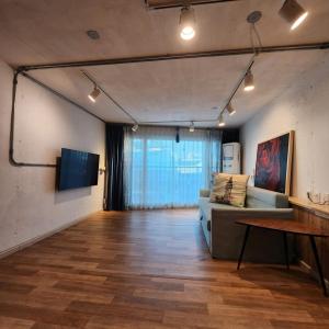 a living room with a couch and a table at Ariene Guesthouse in Gwangju