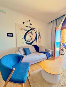a living room with a couch and a table at Apartments Lungo Mare in Sveti Stefan